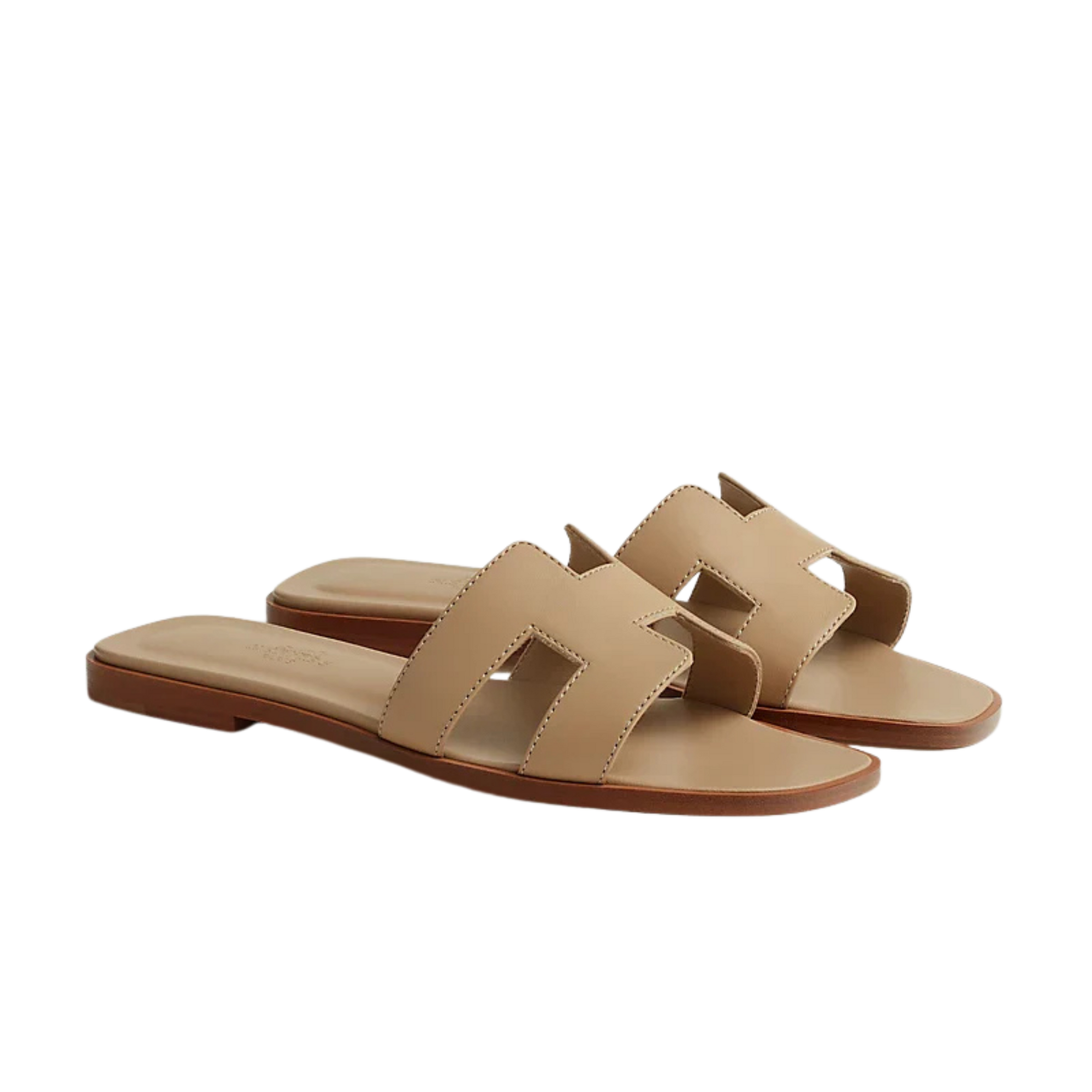 Pair of beige sandals on a white background