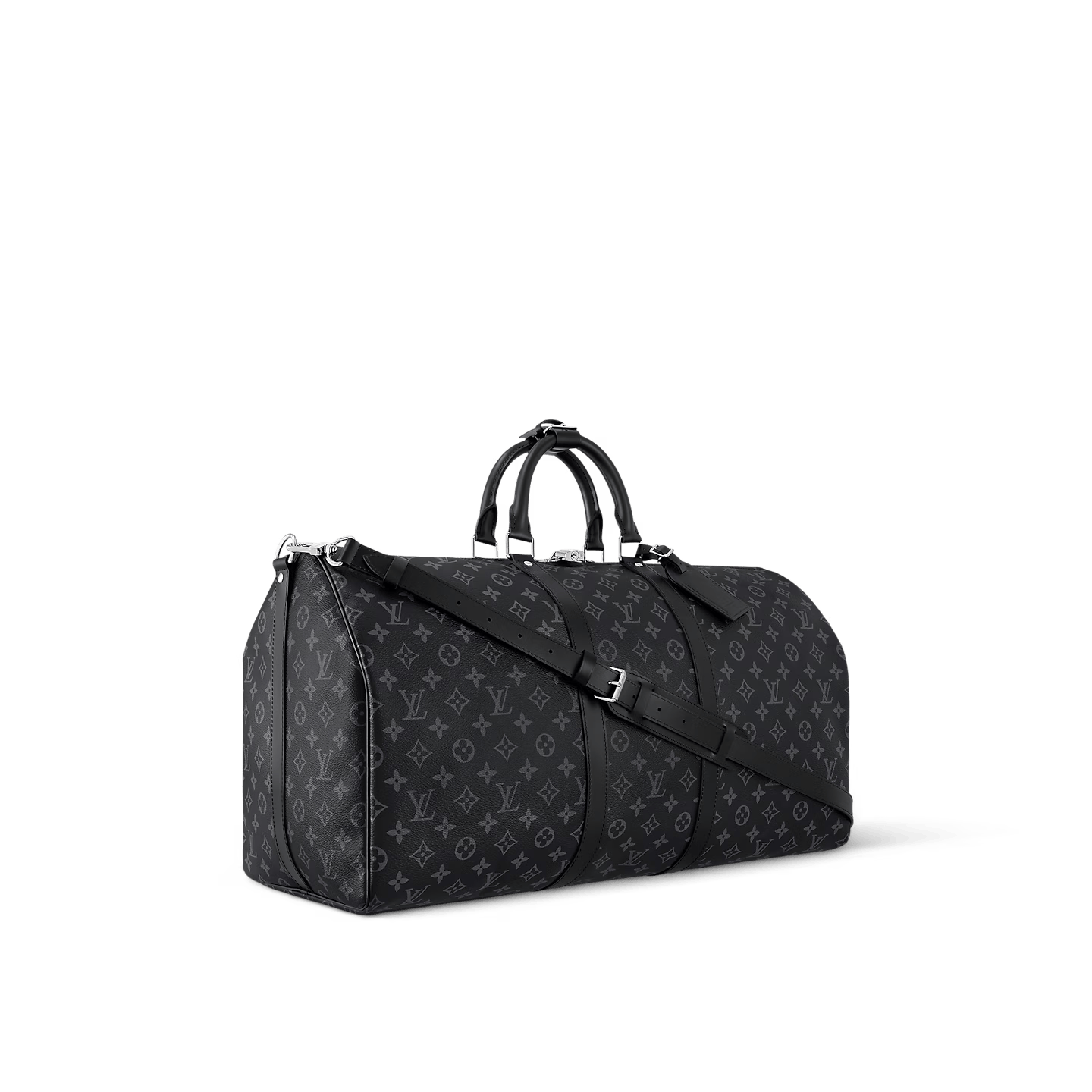 Black oversized weekender bag with leather handles and crossbody strap on luggage