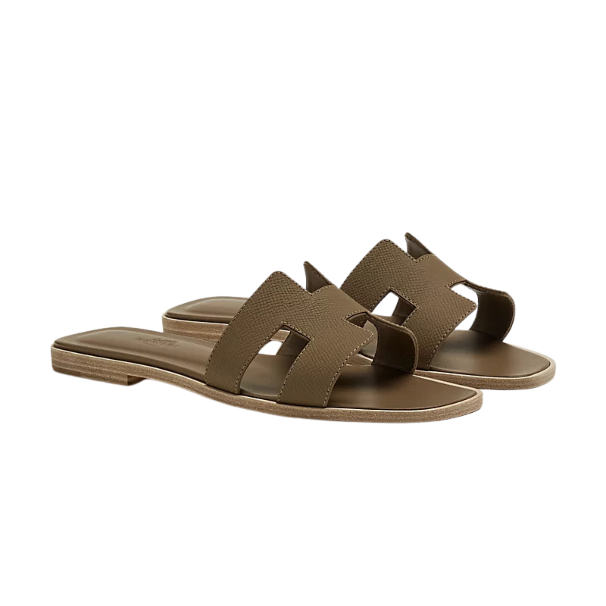 Beige leather slide sandals with gold geometric detail on marble