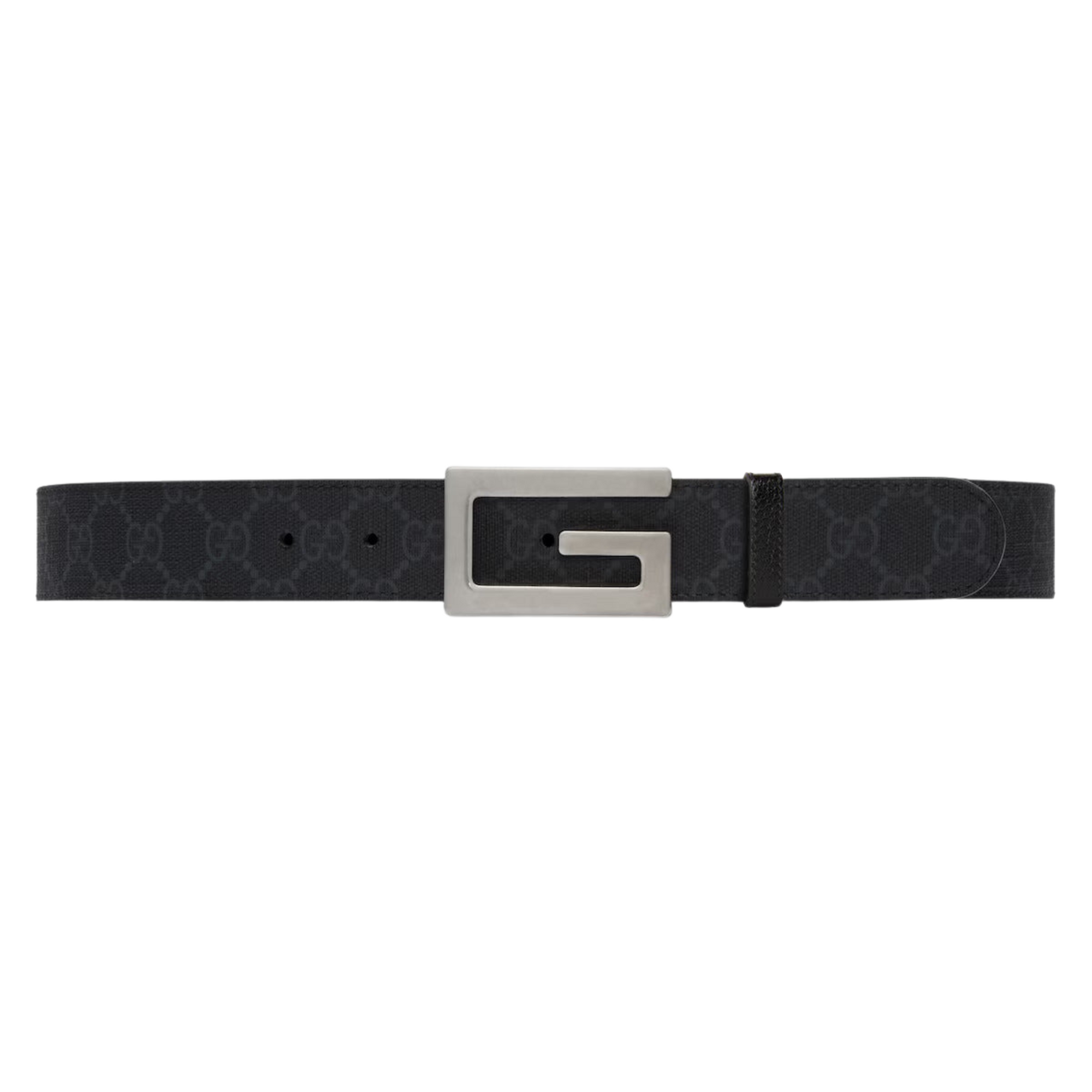Black leather belt with large silver G-shaped buckle on jeans