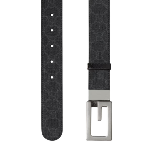 Black patterned belt with a silver buckle on a white background