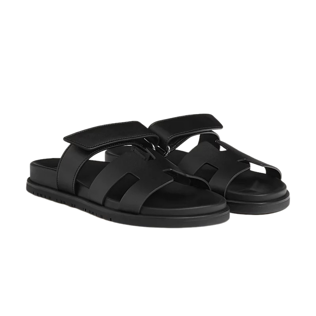 Black sandals with multiple straps on a white background